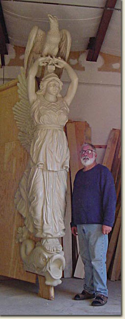 picture of Paul White standing next to olympia figurehead