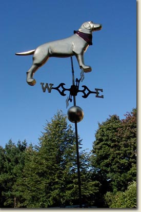 image of handcarved weathervane with dog on top